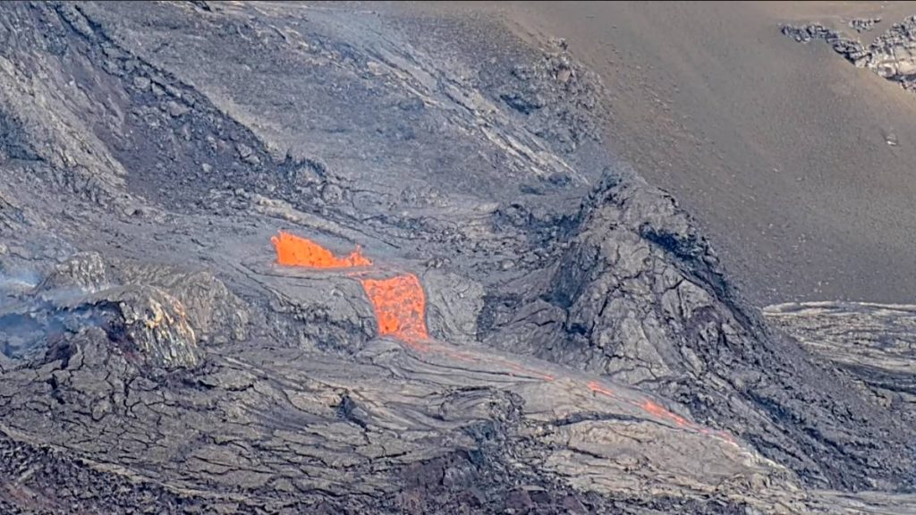 Lava overflowed the north vent cone of Kīlauea and is currently flowing onto the floor of Halemaʻumaʻu crater. (Screenshot: USGS live camera)