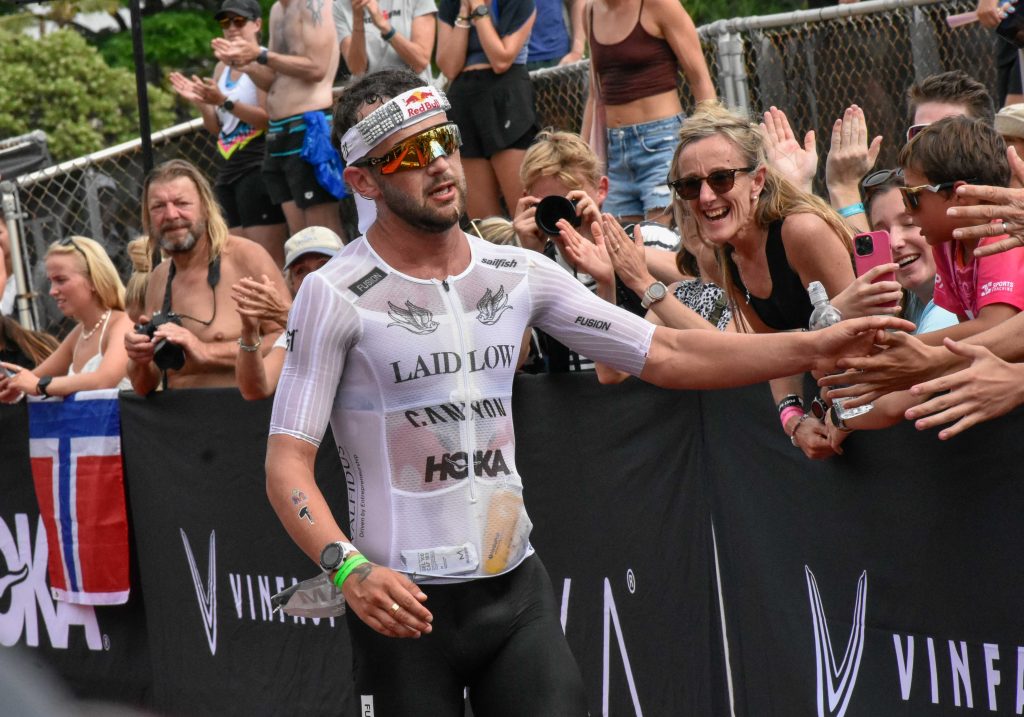 A disappointed Sam Laidlow of France shakes hands with fans as he finishes the 2024 Ironman World Championship in 18th place on Saturday after leading the race for most of the first six hours. (Cammy Clark/Big Island Now)