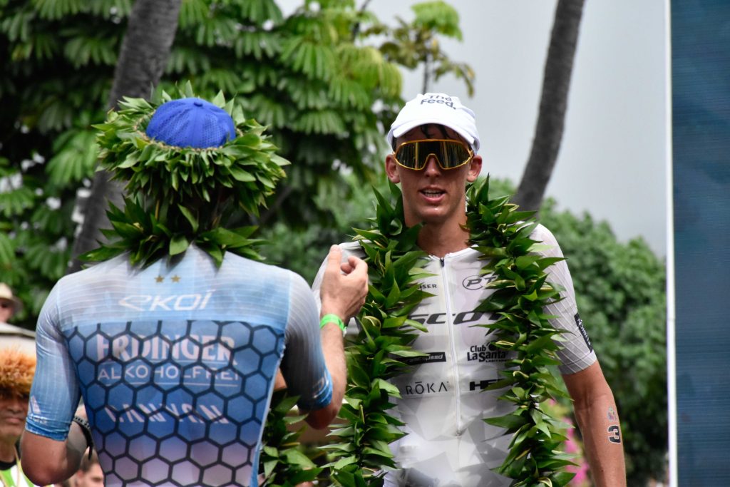 Winner Patrick Lange of Germany (left) congratulates second-place finisher Magnus Ditlev on Saturday after the grueling 2024 VinFast Ironman World Championship in Kona. (Cammy Clark/Big Island Now)