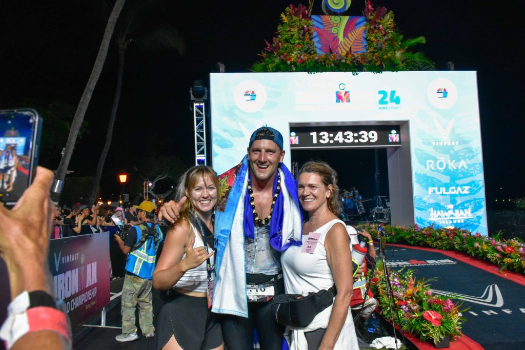 Thirty-year-old Michael Kemp poses for photos after completing the 2024 VInFast Ironman World Championship in his hometown of Kona in a time of 13:23:13. (Cammy Clark/Big Island Now)