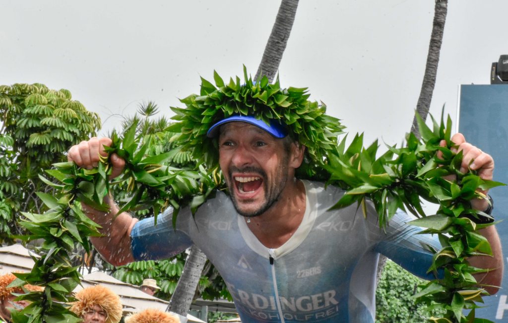 Patrick Lange of Germany celebrates his third Ironman World Championship on Saturday after setting a Kona course record 7 hours, 35 minutes, 53 seconds. (Cammy Clark/Big Island Now)