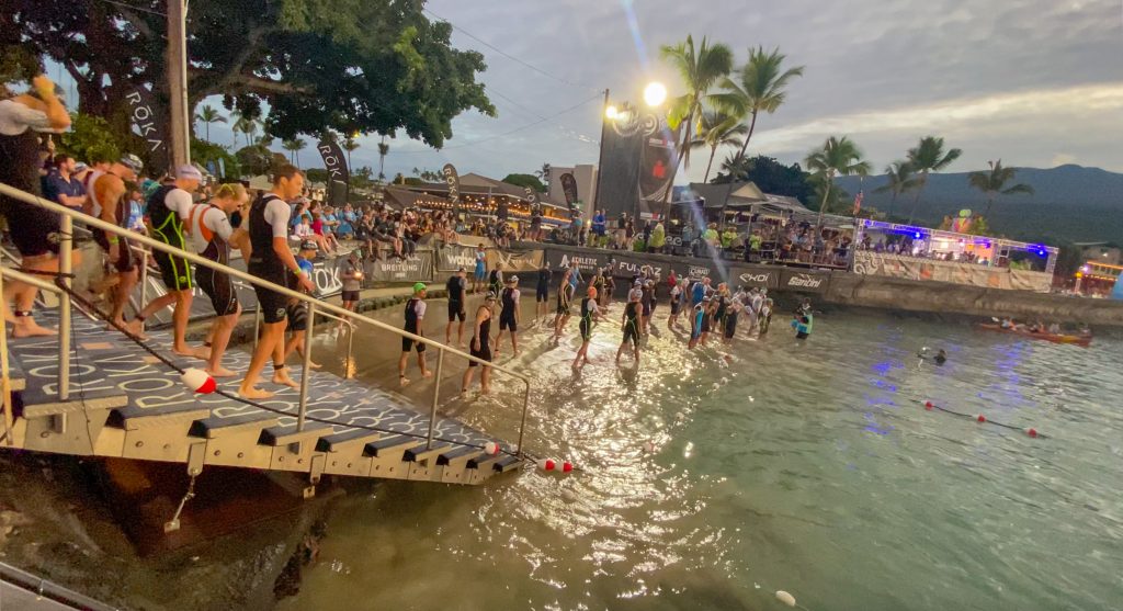 The pro triathletes make their way to Kailua Bay for the start of the 2024 VinFast Ironman World Championship in Kona. (Cammy Clark/Big Island Now)
